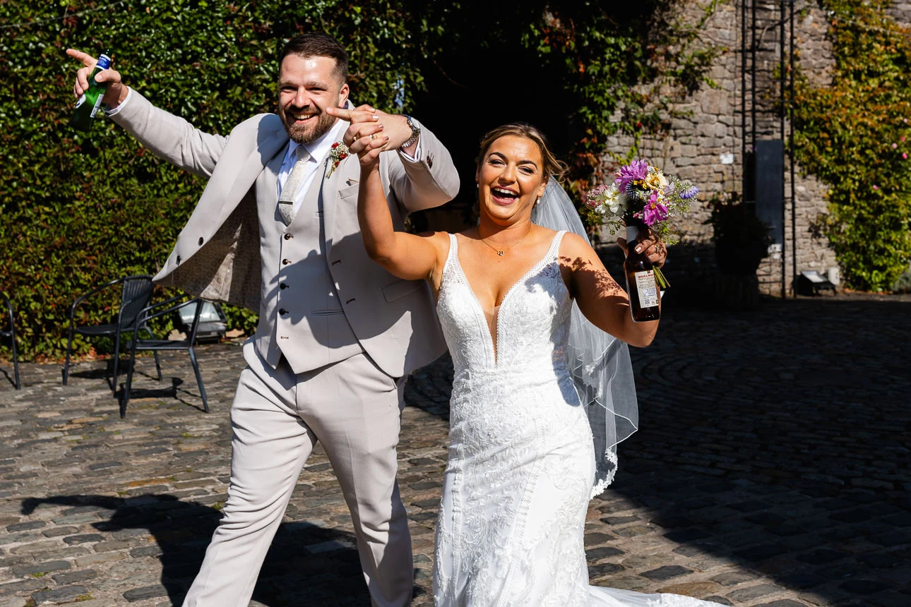 bride and groom running at Walton Castle Wedding venue