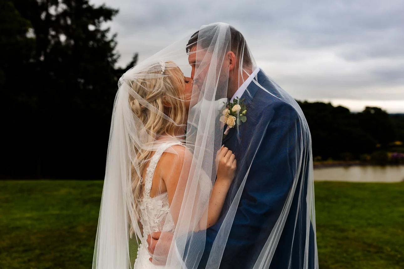 Bride and groom kissing at Upton Barn & Walled Garden - Will and Sarah Photography